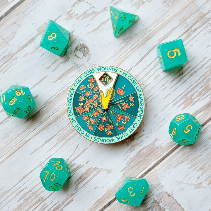 Seconds Sale! Cure Wounds Spinner Pin - Geeky merchandise for people who play D&D - Merch to wear and cute accessories and stationery Paola's Pixels