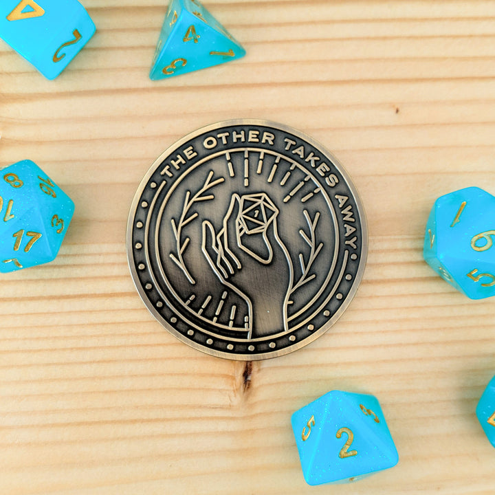 What One Hand Gives d2 Coin - Geeky merchandise for people who play D&D - Merch to wear and cute accessories and stationery Paola's Pixels