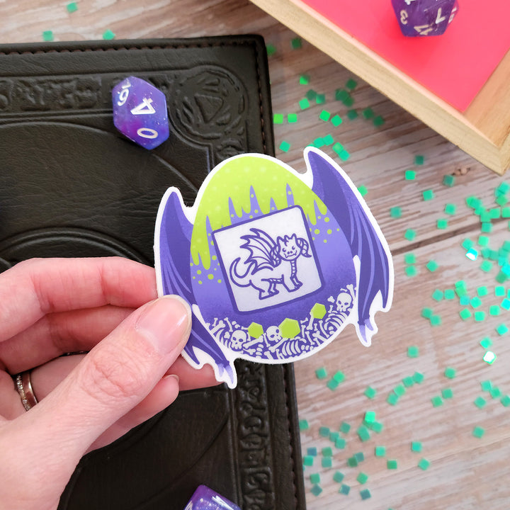 Dragon Tamagotchi Sticker - Geeky merchandise for people who play D&D - Merch to wear and cute accessories and stationery Paola's Pixels