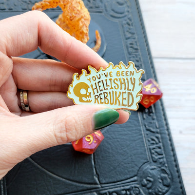 You've Been Hellishly Rebuked Enamel Pin - Geeky merchandise for people who play D&D - Merch to wear and cute accessories and stationery Paola's Pixels