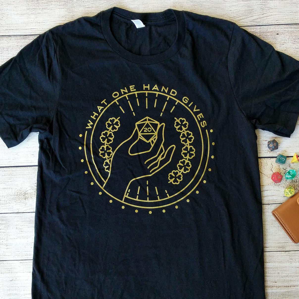 What One Hand Gives The Other Takes Away T-Shirt - Geeky merchandise for people who play D&D - Merch to wear and cute accessories and stationery Paola's Pixels