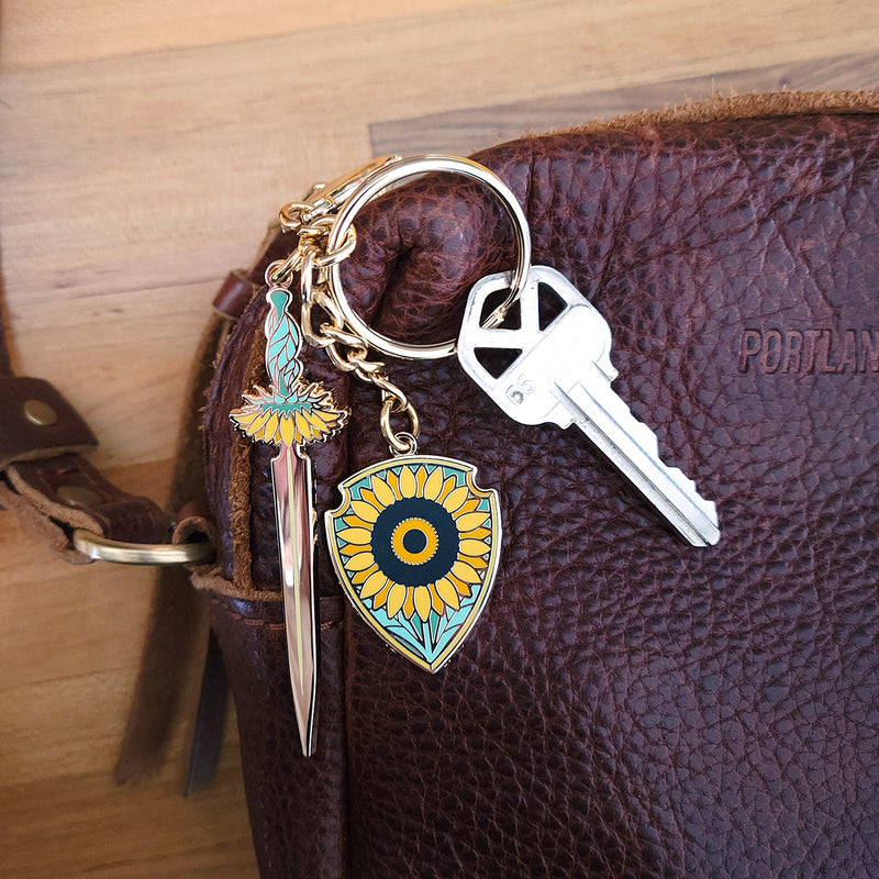 Sunflower Sword and Shield Enamel Keychain - Geeky merchandise for people who play D&D - Merch to wear and cute accessories and stationery Paola&