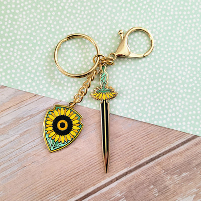 Sunflower Sword and Shield Enamel Keychain - Geeky merchandise for people who play D&D - Merch to wear and cute accessories and stationery Paola's Pixels
