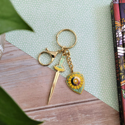 Sunflower Sword and Shield Enamel Keychain - Geeky merchandise for people who play D&D - Merch to wear and cute accessories and stationery Paola's Pixels