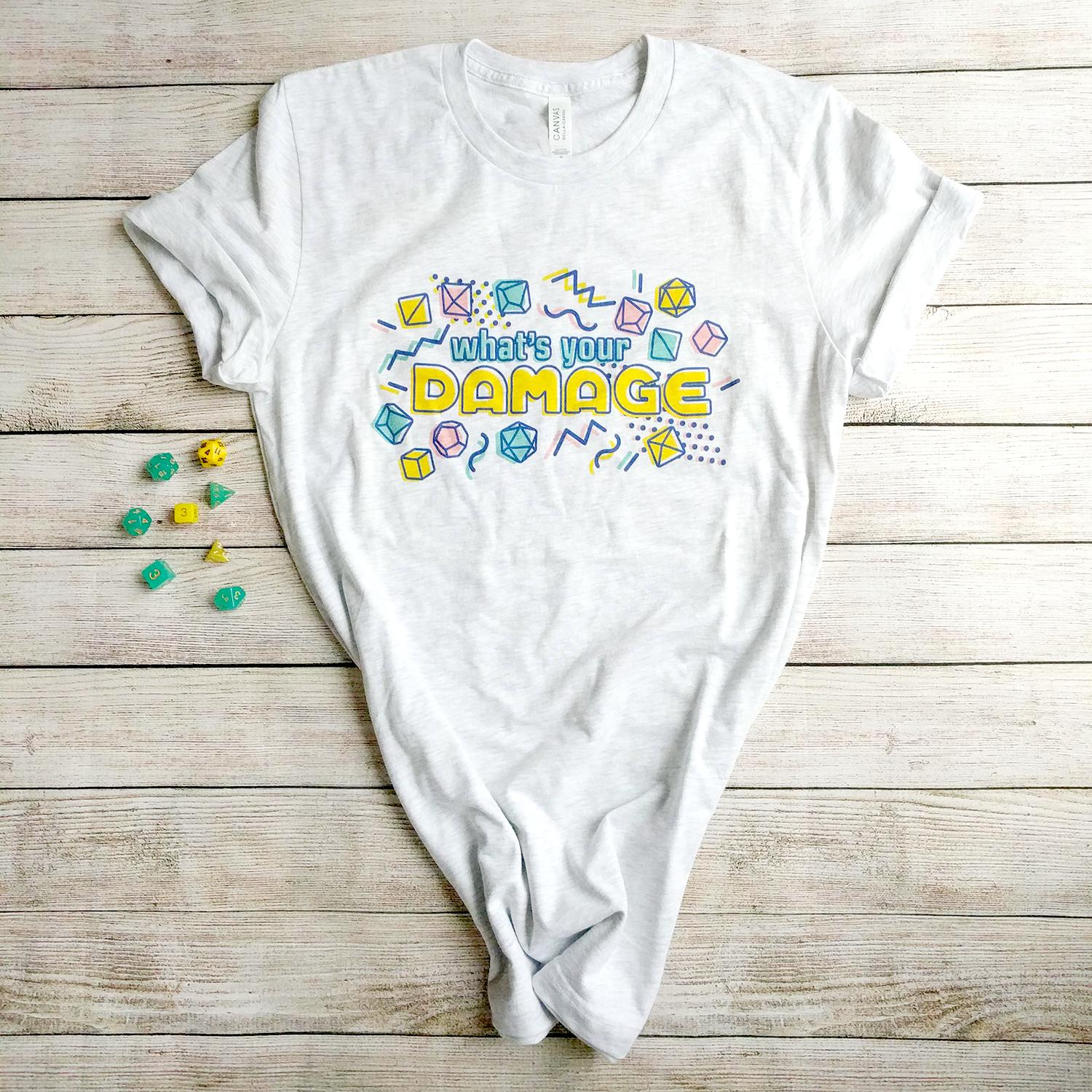 What's Your Damage t-Shirt - Geeky merchandise for people who play D&D - Merch to wear and cute accessories and stationery Paola's Pixels