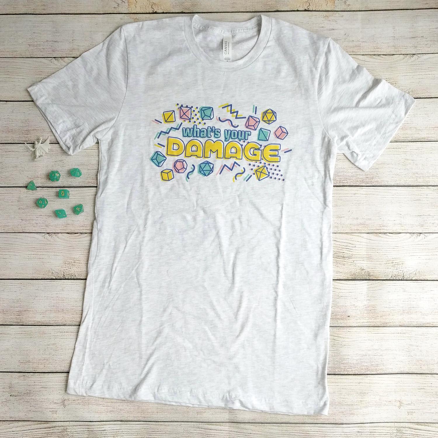 What's Your Damage t-Shirt - Geeky merchandise for people who play D&D - Merch to wear and cute accessories and stationery Paola's Pixels