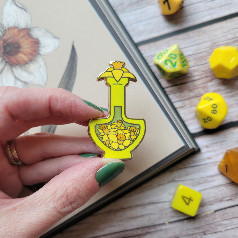 Yellow Daffodil Potion Enamel Pin - Geeky merchandise for people who play D&D - Merch to wear and cute accessories and stationery Paola&